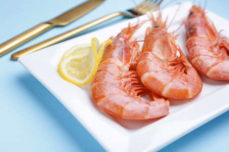 Plate with tasty shrimps on color background, closeupの写真素材