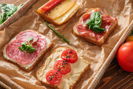 Different tasty sandwiches on tray, closeup