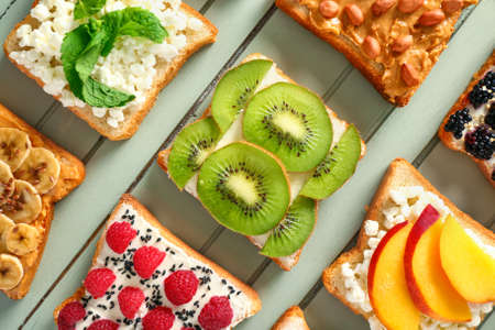 Different tasty sandwiches on wooden backgroundの写真素材