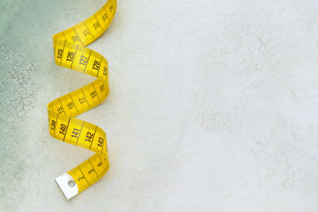 Measuring tape on light background
