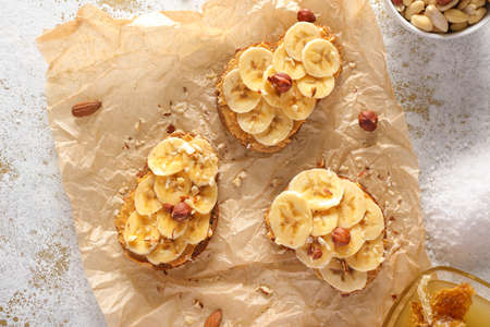 Tasty sweet sandwiches with banana on parchmentの写真素材
