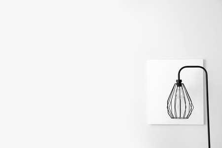 Stylish lamp near light wall