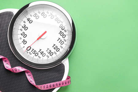 Scales and measuring tape on color background. Weight loss conceptの写真素材