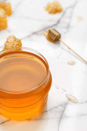 Jar of sweet honey on tableの写真素材