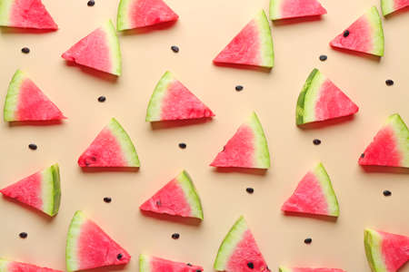Many slices of watermelon on color background