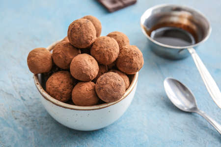 Bowl with tasty sweet truffles on tableの写真素材