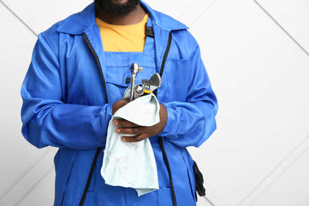 African-American car mechanic near light wallの写真素材