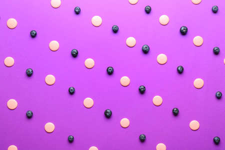 Many chocolate chips and blueberry on color background