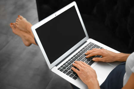 Young woman working on laptop, closeup