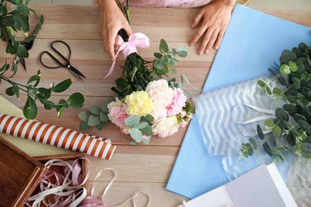Female florist making beautiful bouquet in shopの写真素材
