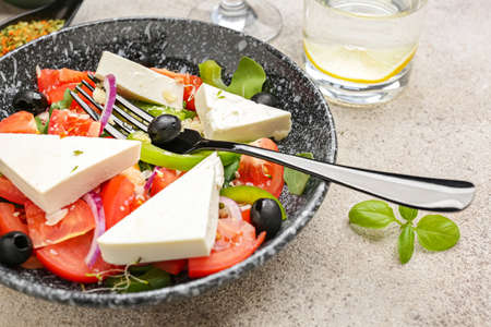 Plate with tasty Greek salad on tableの写真素材