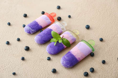 Tasty blueberry ice cream on color backgroundの写真素材