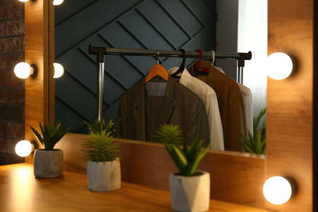 Table with mirror in modern dressing room, closeup