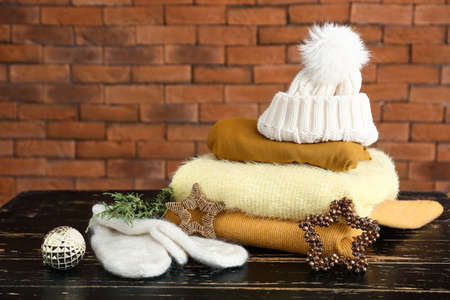 Winter clothes with Christmas decor on wooden tableの写真素材