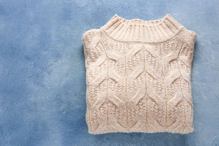 Warm sweater on color background