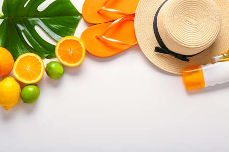 Summer composition with tropical fruits and beach accessories on white background