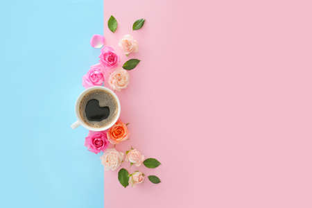 Beautiful rose flowers with cup of coffee on color backgroundの写真素材