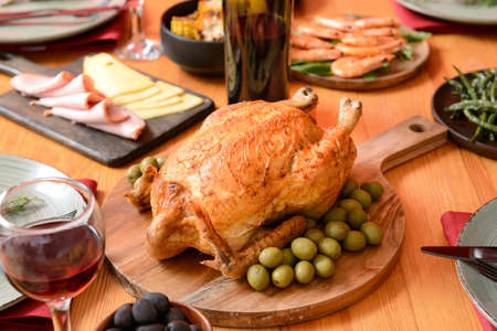 Tasty chicken with olives on served table