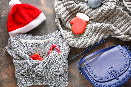 Warm clothes and Christmas sweets on gray backgroundの写真素材
