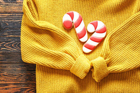 Warm sweater and Christmas cookies on wooden backgroundの写真素材