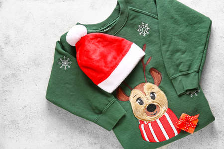 Set of Christmas clothes on light backgroundの写真素材