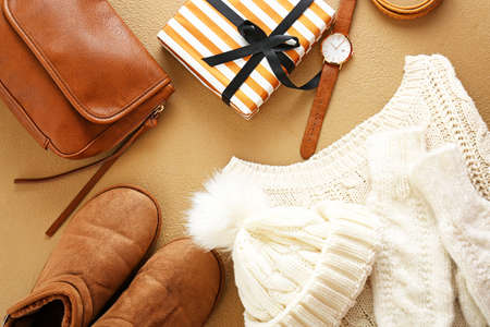Set of warm clothes, Christmas gift and accessories on color backgroundの写真素材
