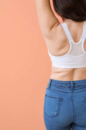 Young body positive woman on color background