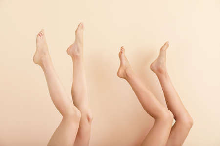 Women with beautiful legs after depilation on color backgroundの写真素材