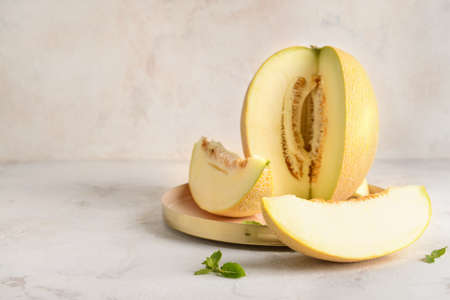 Plate with tasty melon on gray backgroundの写真素材