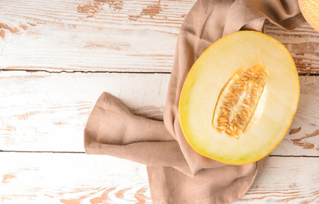 Tasty melon on white wooden background