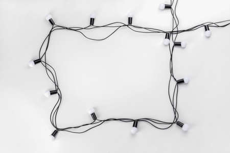 Frame made of Christmas lights on white backgroundの写真素材