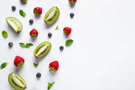 Sweet ripe fruits and berries on white background