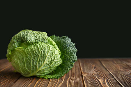 Fresh savoy cabbage on wooden tableの写真素材