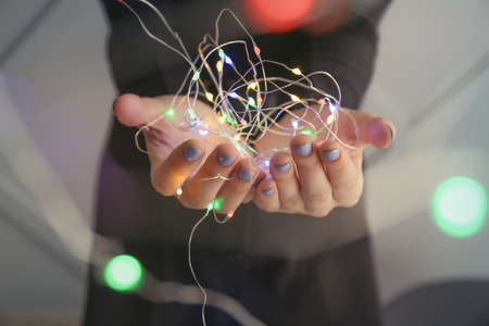 Young woman with glowing garland, closeupの写真素材