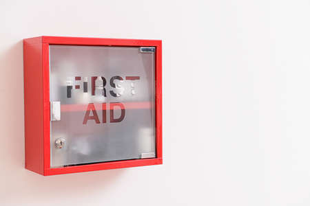 Wall mounted first aid kit on light backgroundの写真素材