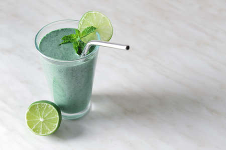 Glass of healthy spirulina smoothie on tableの写真素材
