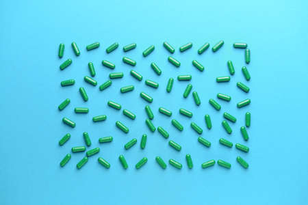 Spirulina pills on color background