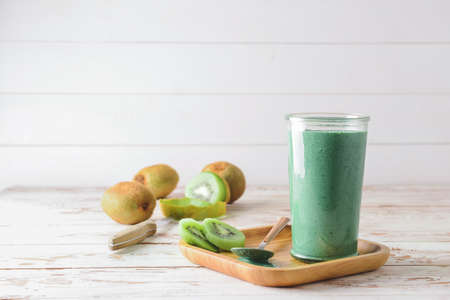 Glass of healthy spirulina smoothie on tableの写真素材