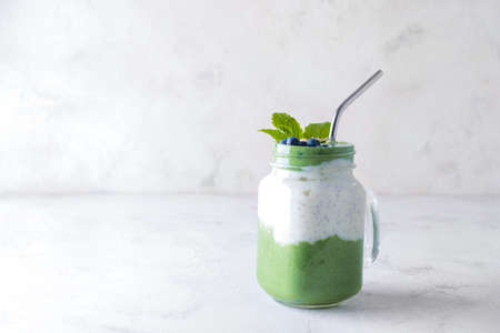 Mason jar of healthy spirulina smoothie on tableの写真素材