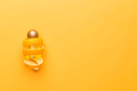 Bottle of orange essential oil on color background