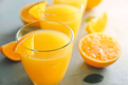 Glasses of fresh orange juice on table, closeupの写真素材