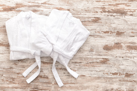 Soft bathrobes on wooden backgroundの写真素材