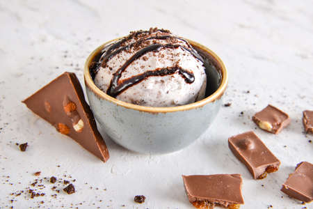 Bowl with tasty ice cream on table