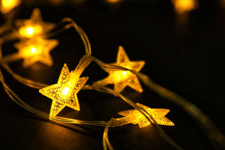 Beautiful Christmas lights on dark background, closeup