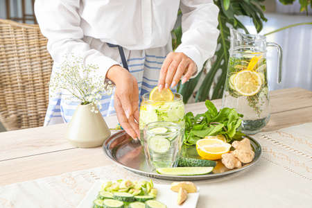 Woman preparing healthy infused water