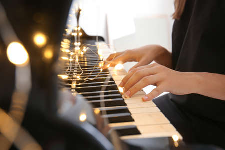 Young woman playing piano, closeupの写真素材