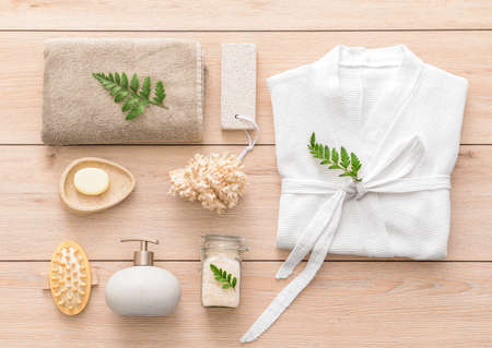 Bathrobe and set of spa items on wooden backgroundの写真素材