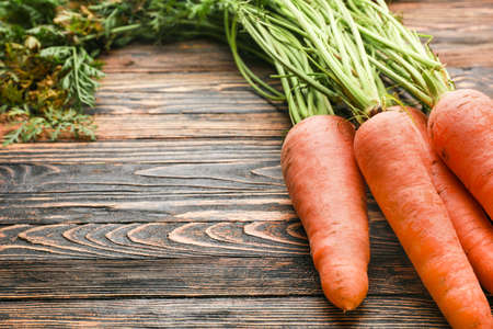 Fresh carrots on wooden backgroundの写真素材