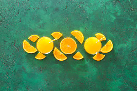 Composition with fresh orange juice on table