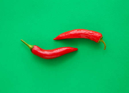 Red chili peppers on color background